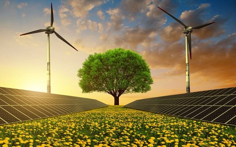 Solar energy panels, wind turbines and tree on dandelion field at sunset. Clean energy.